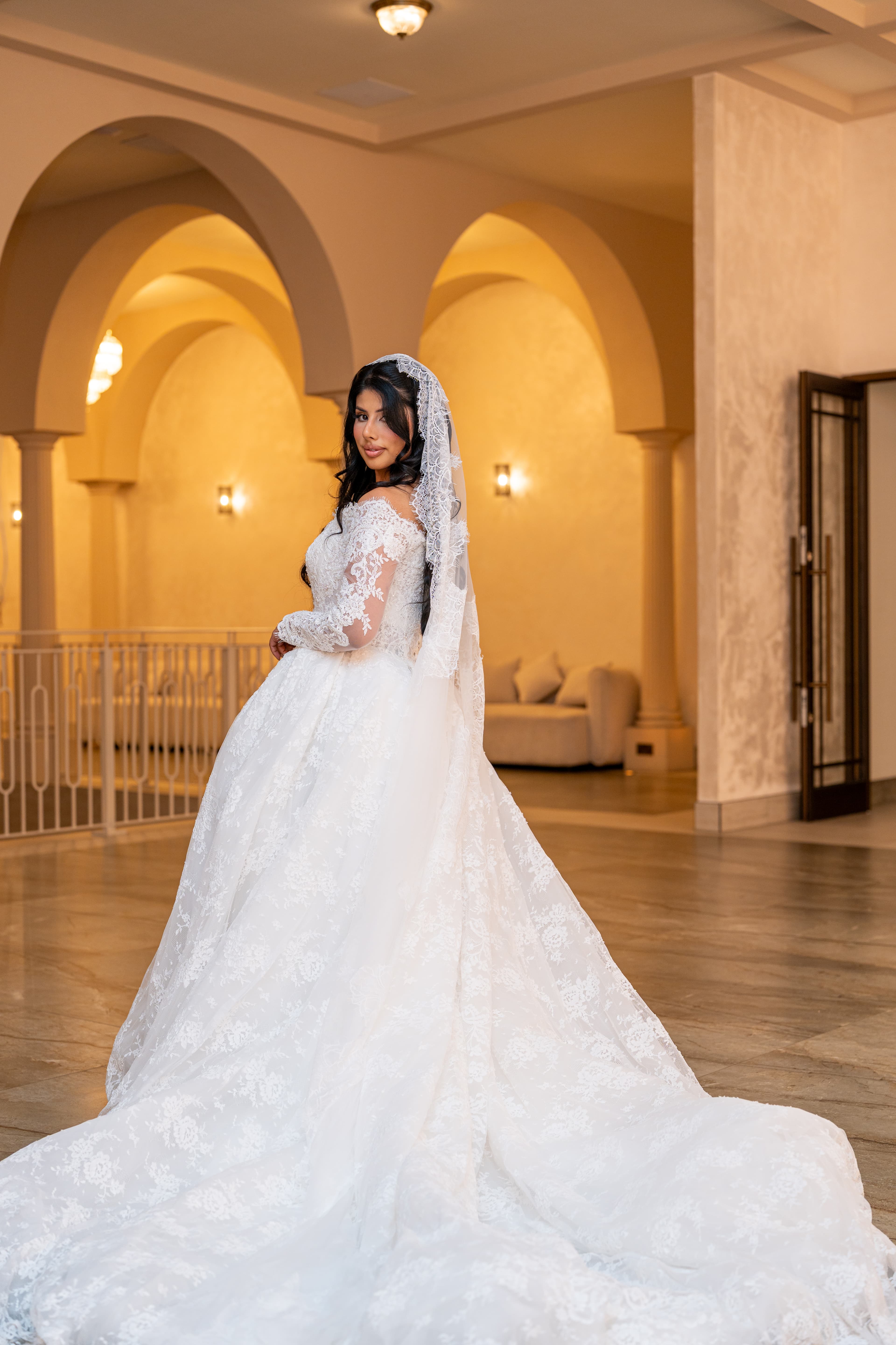 Full-length bridal portrait in a white gown.